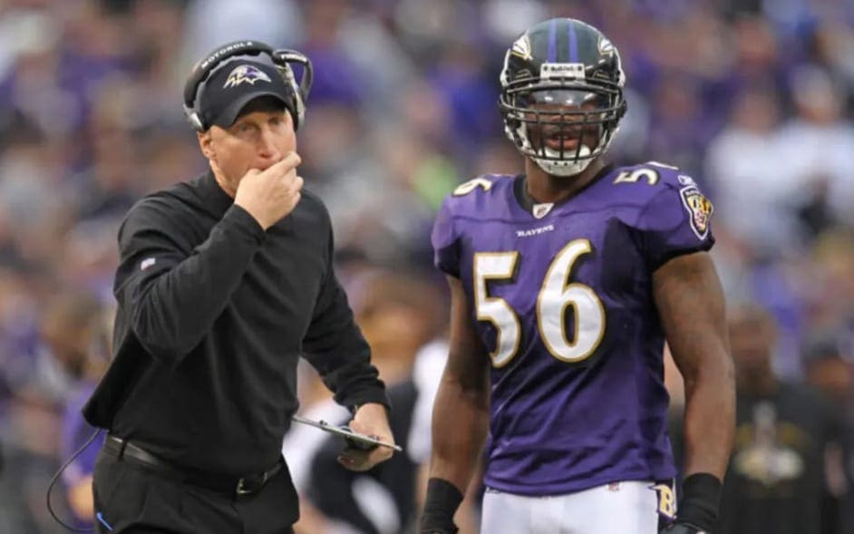 Baltimore Ravens assistant head coach Jerry Rosburg calls the defense over to met with he and linebacker Edgar Jones (56) before a goal line play against the Cincinnati Bengals at M&T Bank Stadium. Mandatory Credit: Mitch Stringer-USA TODAY Sports